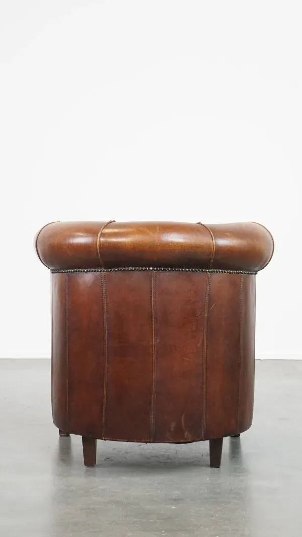 Illustration numéro 2 du produit Fauteuil club en cuir de mouton de couleur cognac et finition passepoilée